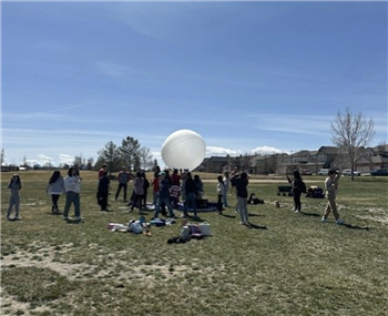 students launching a near space weather balloon
